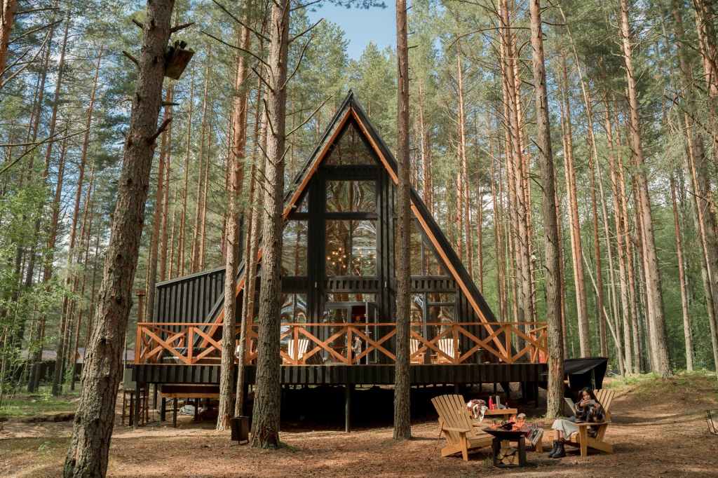 a wooden house with glass wall on camping site